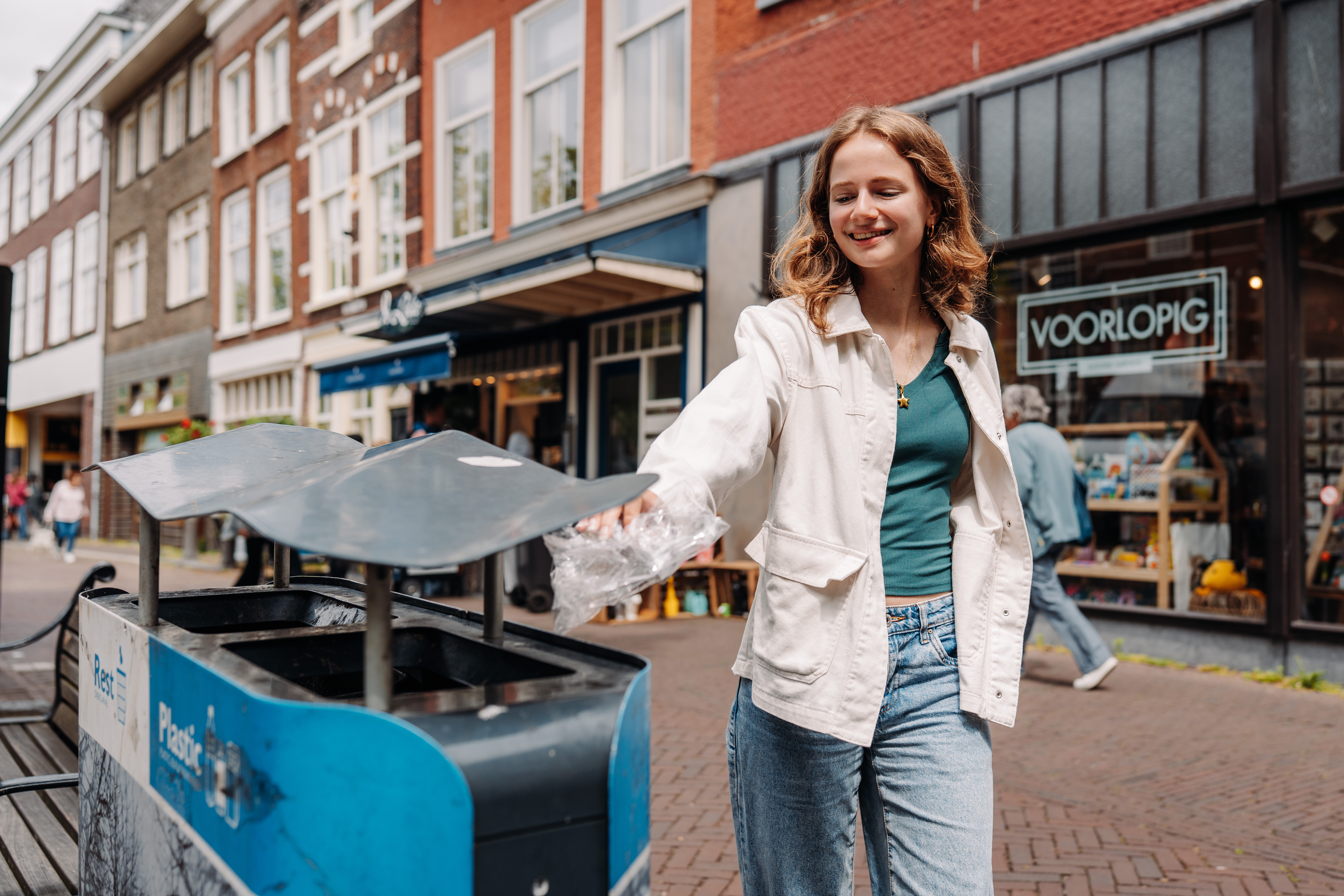 Meisje gooit plastic weg